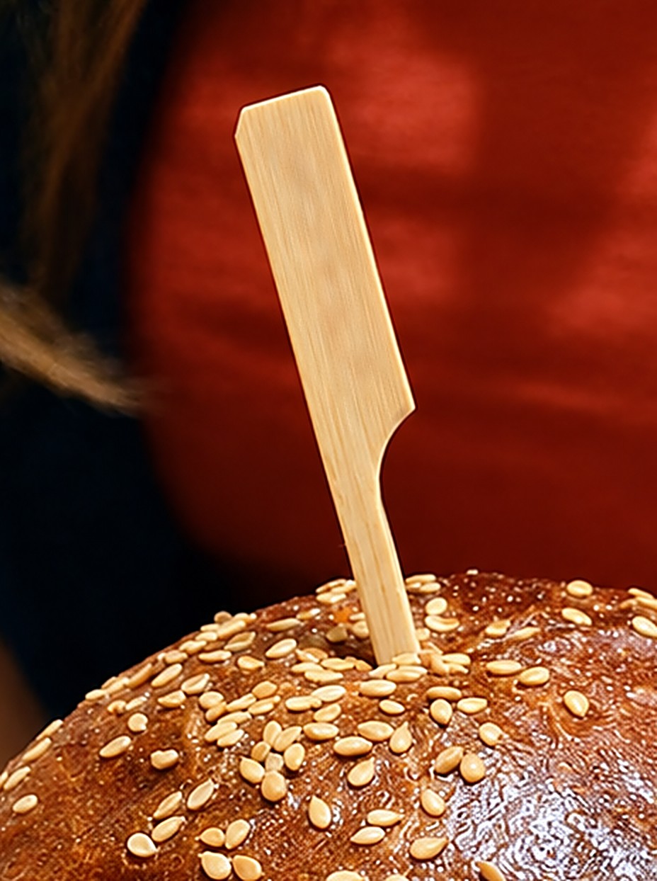Bamboo pick standing in a sesame brioche bun, engraved with your name or logo